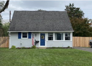 a big house with a strong wooden fence